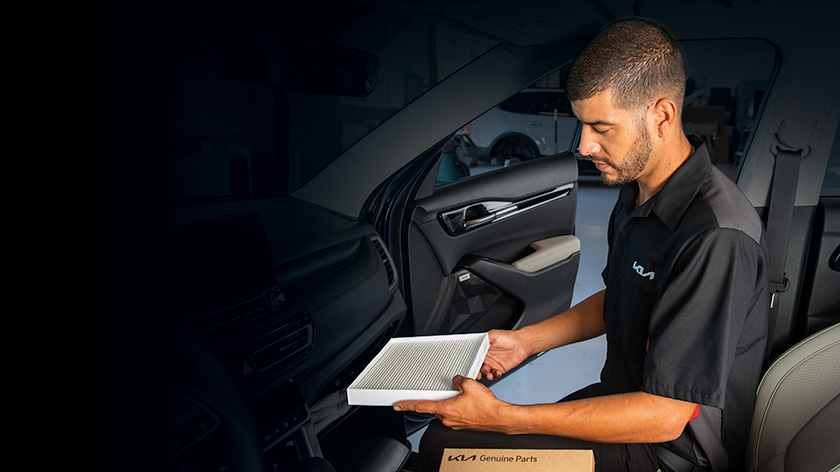 Mechanic is checking the inspection list in front of a open bonnet