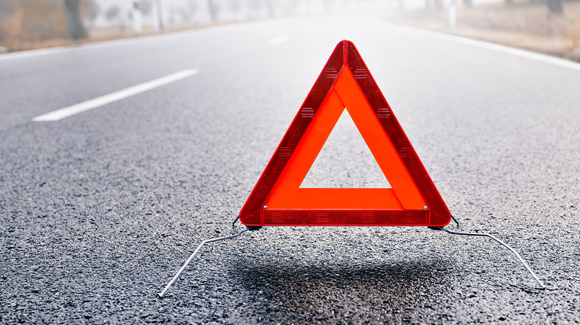 Close-up of emergency warning triangle sign on the road