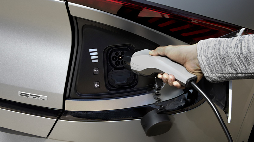 Close-up of a hand charging the EV6