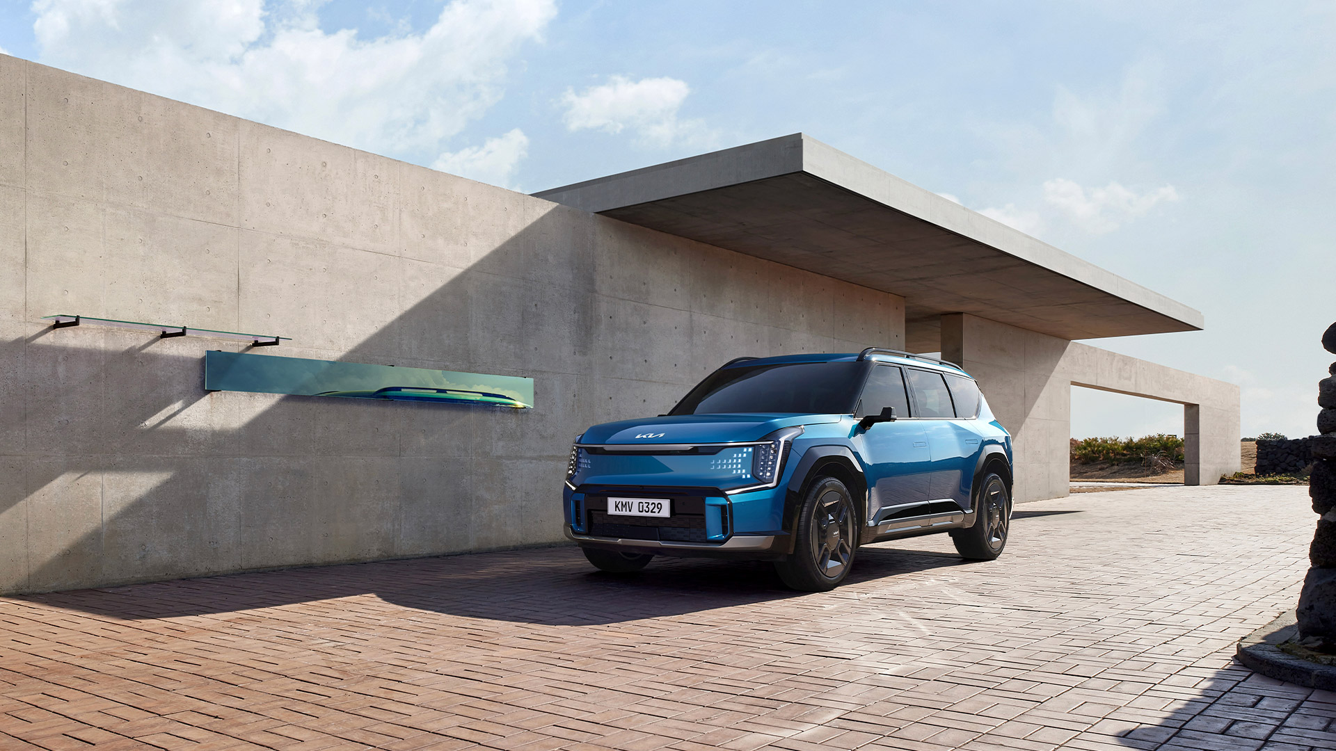 EV9 parked in front of a concrete building