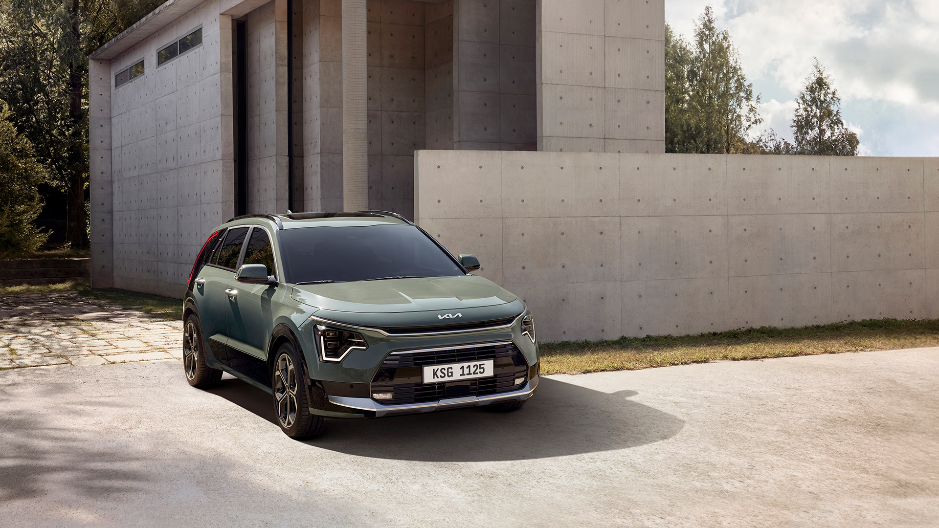 Front side view of Kia Niro parked in front of the building